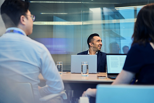 A Standard Chartered colleague presents his work in a meeting.